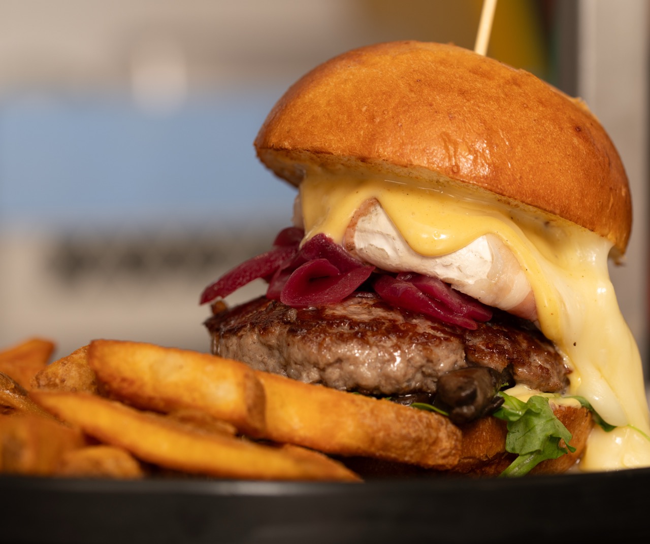 Gourmet burger with melted cheese and caramelized onions